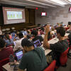 A podiatry student raises his hand during a lecture.