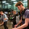 Students learning to use a video camera in a film and media arts class.