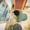 aerial view of an art student painting on a canvas.
