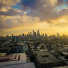 An aerial view of the Philadelphia skyline at sunset from Temple's Main Campus. The sky is bright yellow and orange.