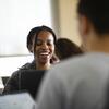 A Temple student laughs along with her peers during class discussion.