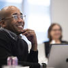 A Temple professor smiles during a student presentation.